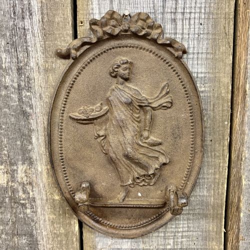 Neoclassical Style Cast Iron Two-Hook Decorative Wall Plaque: This cast iron wall-mounted decorative plaque features a central relief in the Neoclassical style. The central oval medallion contains a raised figure of a woman in flowing, classical attire walking w