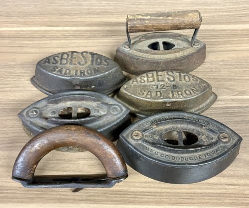A Collection of Antique Cast Iron Asbestos and Schreiber and Conchar Sad Iron Bases and Handles: This collection consists of several antique cast iron sad iron components, featuring branded examples from the late 19th to early 20th century. The lot includes a base embossed with SCHREIBER & CONCHA