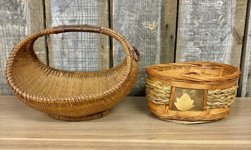 Two Vintage Woven Rattan and Mixed Media Baskets: This lot features two vintage decorative baskets of varying forms and materials. The first is a boat-shaped basket, often referred to as a gondola basket, constructed from finely woven rattan. It has 