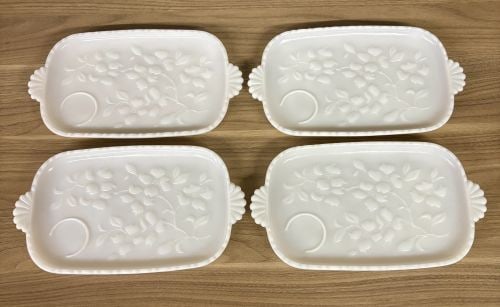 A Set of Four MacBeth-Evans Dogwood Pattern Milk Glass Snack Trays: A set of four vintage milk glass snack or luncheon trays in the Dogwood pattern, attributed to the MacBeth-Evans Glass Company. Each tray is constructed from opaque white milk glass in a rectangular f