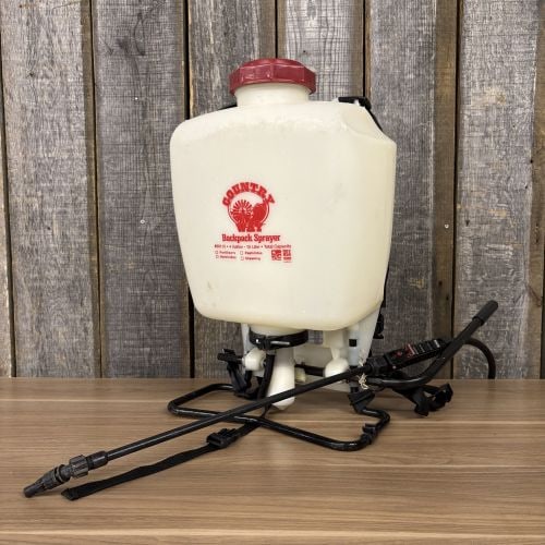 Country Way 4 Gallon Manual Backpack Sprayer Model 60115: A Country Way manual backpack sprayer, model number 60115. The unit features a translucent white plastic tank with a total capacity of 4 gallons or 15 liters. The rear of the tank is molded with gradu
