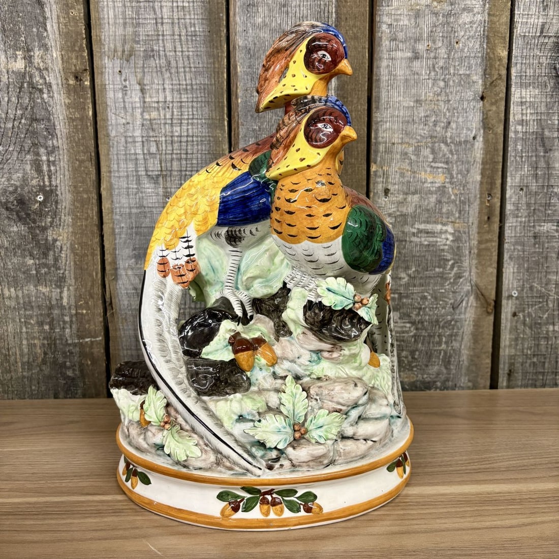 Fitz and Floyd Autumn Bounty Ceramic Pheasant Pair Figurine: A large-scale polychrome-glazed ceramic figurine from the Fitz and Floyd Autumn Bounty collection. The composition features two pheasants perched on a rocky, moss-textured base detailed with applied o