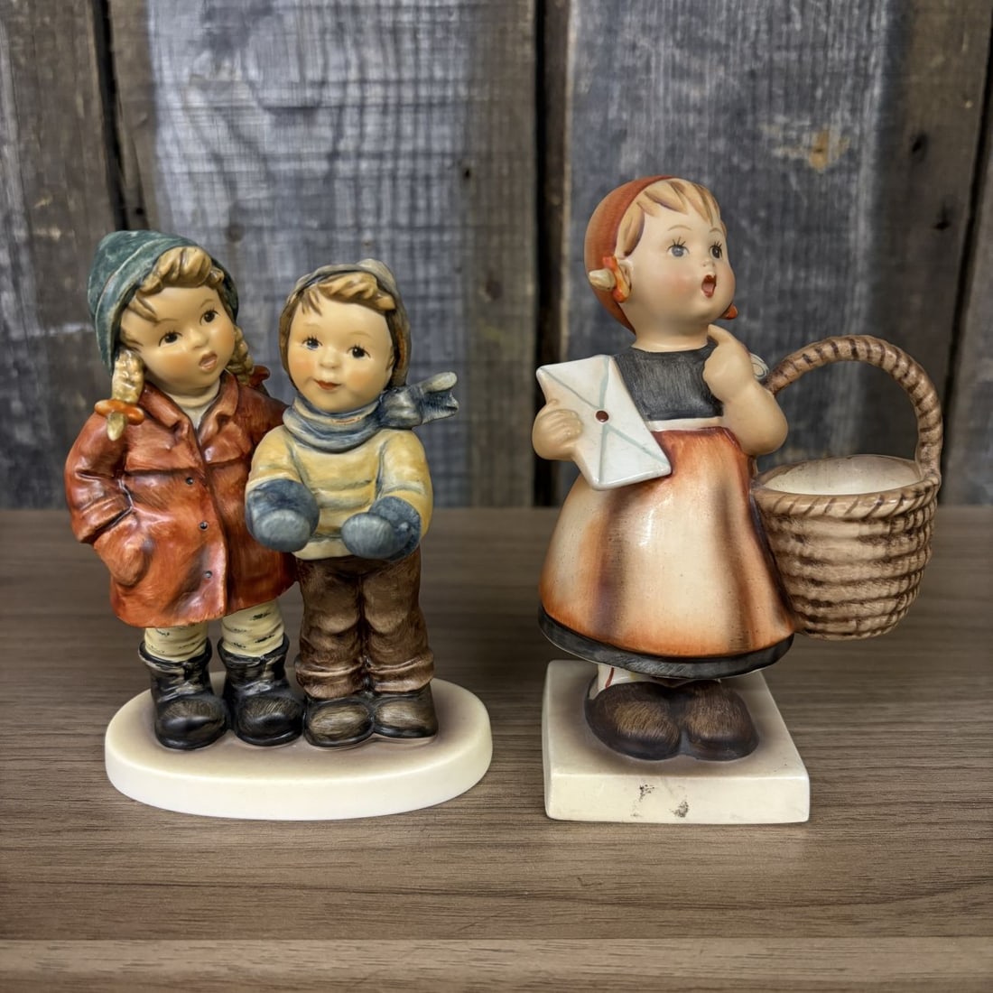Two Goebel M.J. Hummel Porcelain Figurines, Meditation and A Star For You: This lot features two hand-painted porcelain figurines from the M.J. Hummel collection by Goebel, Germany. The first figurine is titled A Star For You (Ein Stern f¸r dich) and depicts two children in
