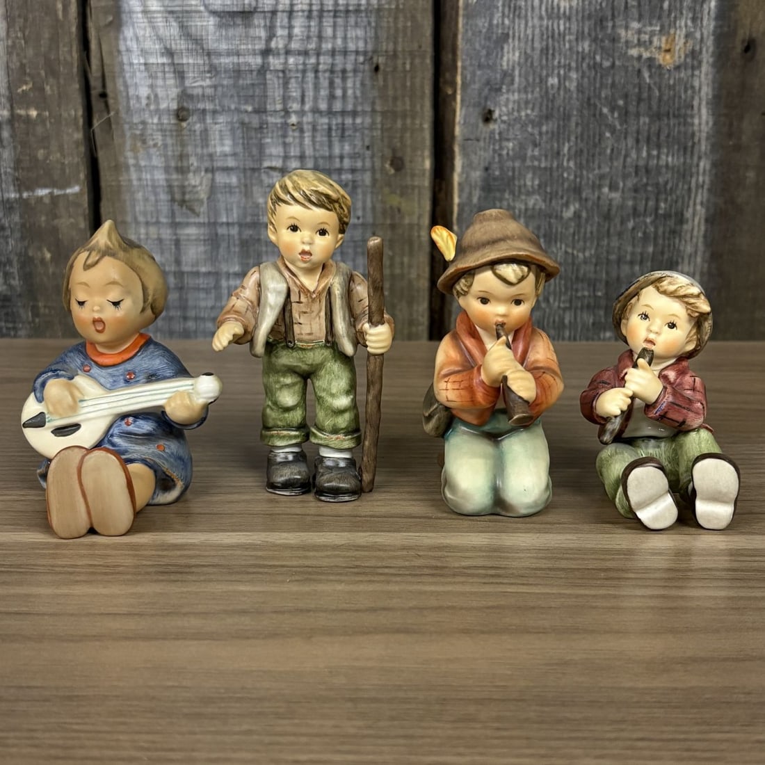 A Set of Four Goebel M.I. Hummel Hand-Painted Ceramic Musical and Wandering Child Figurines (1 of 10)