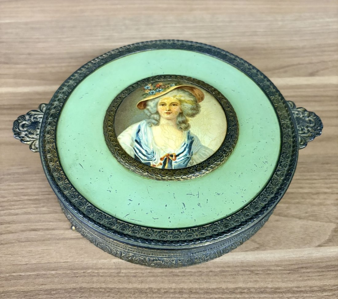 Neo-Rococo Style Gilt Metal and Enameled Footed Dresser Box with Miniature Portrait: A circular footed dresser box constructed from patinated gold-tone cast metal featuring ornate floral and foliate relief bands. The lid is decorated with a wide mint-green enameled border surrounding 