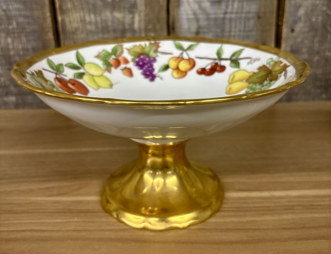 Haas and Cajzek Czech Porcelain Hand Painted Fruit Pedestal Bowl Signed Kelan Webb 1995: This handmade fine porcelain pedestal bowl, also known as a compote, was manufactured by Haas and Cajzek in the Czech Republic. The interior of the bowl features a hand-painted fruit wreath motif depi