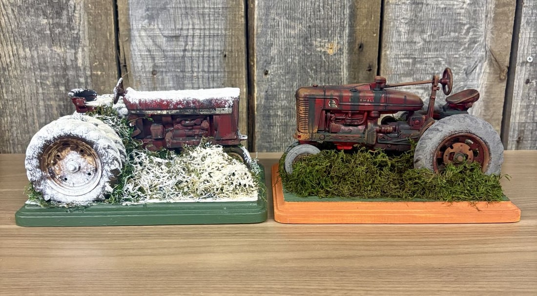 A Pair of Custom Weathered 1/16 Scale Ertl Die-Cast Model Tractor Dioramas: This lot features a pair of 1/16 scale die-cast model tractors manufactured by Ertl that have been professionally or semi-professionally customized into detailed scenic dioramas. Both models are mount