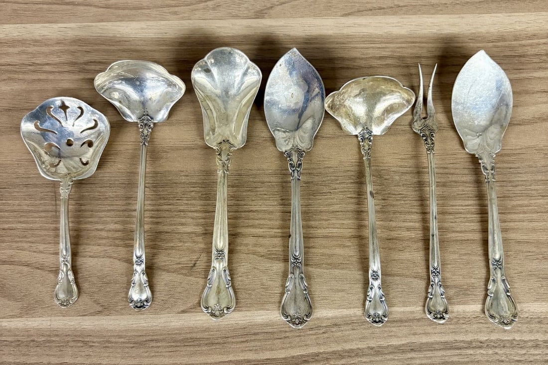 A Group of Seven Gorham Strasbourg Sterling Silver Serving Flatware Pieces: A group of seven solid sterling silver serving flatware pieces manufactured by the Gorham Manufacturing Company in the Strasbourg pattern. The collection includes one pierced bonbon spoon, two cream l