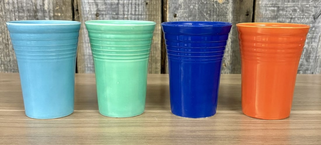 A Set of Four Homer Laughlin Fiesta Ringed Water Tumblers: A set of four glazed earthenware tumblers from the Fiesta line by the Homer Laughlin China Company. Each tumbler features a tapered cylindrical form with the signature concentric ring design character