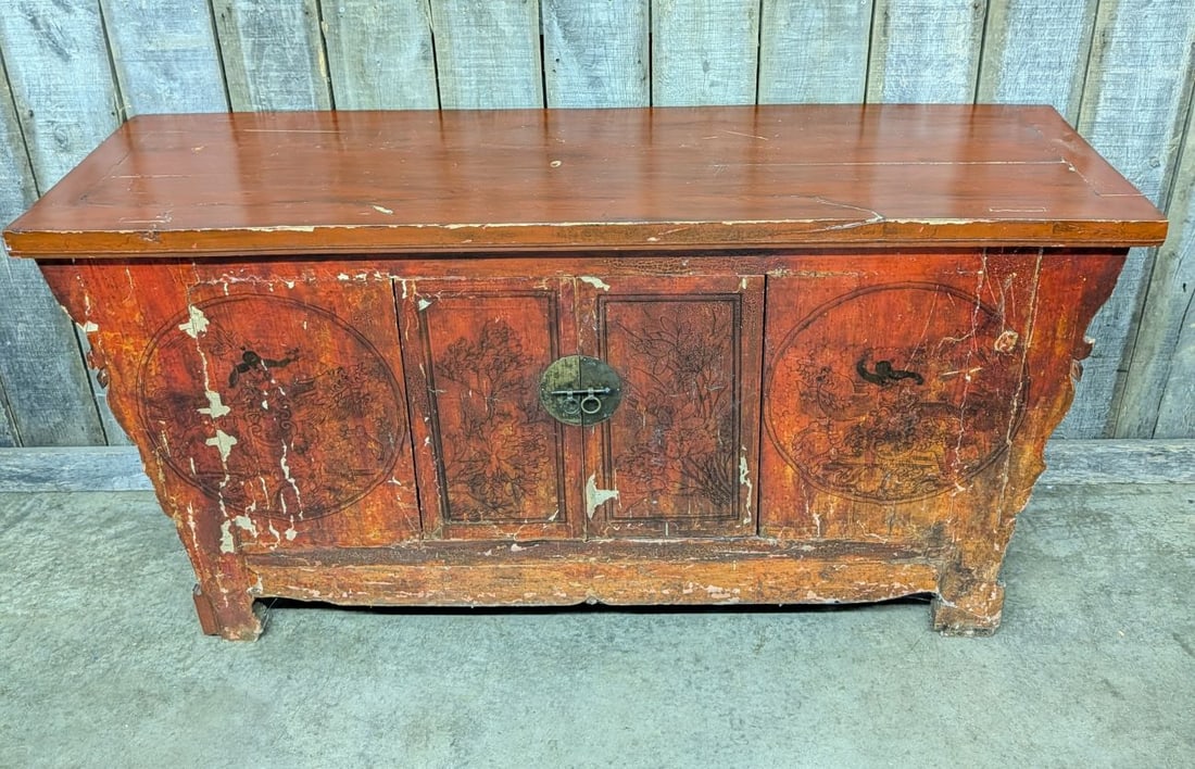 Large Chinese Red Lacquered Altar Cabinet with Hand Painted Decoration: A large Chinese altar cabinet or sideboard, characterized by a traditional form with a wide, rectangular overhanging top and flared side spandrels. The piece is constructed from wood with a traditiona