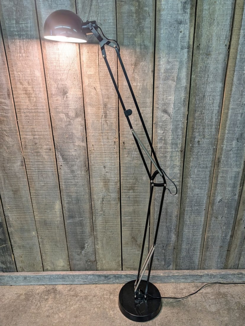 Oversized Black Enameled Adjustable Arm Architect Style Floor Lamp: This is an oversized articulating-arm floor lamp constructed in the traditional architect or drafting style. The piece is fabricated from black-enameled metal and features an adjustable body supported