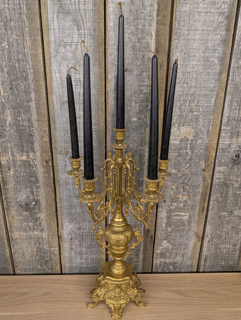 Rococo Revival Style Cast Brass Five Light Candelabra: This five light candelabra is constructed from heavy cast brass in the Rococo Revival style. The piece features a central column supporting four scrolling arms, each adorned with acanthus leaves and C