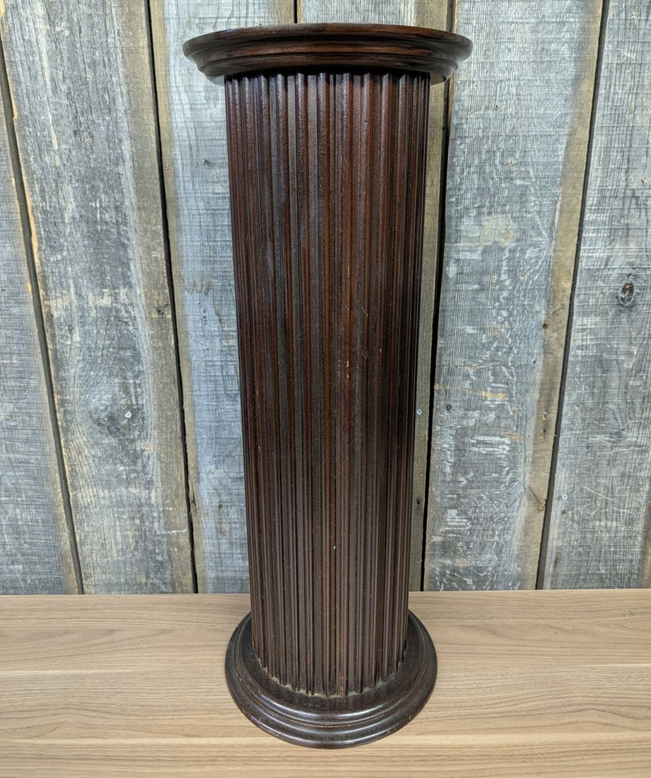 Neoclassical Style Fluted Wood Column Pedestal: A classical-style pedestal display stand constructed from wood with a dark mahogany-tone stained and polished finish. The piece features a vertically fluted cylindrical shaft positioned between a circ