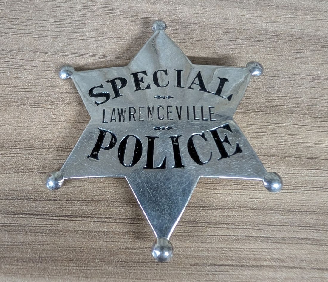 Obsolete Lawrenceville Special Police Nickel-Plated Six-Point Star Badge: This mid-20th century obsolete American special police badge is designed for the jurisdiction of Lawrenceville. Struck from a single piece of nickel-plated base metal, the badge features a six-pointed