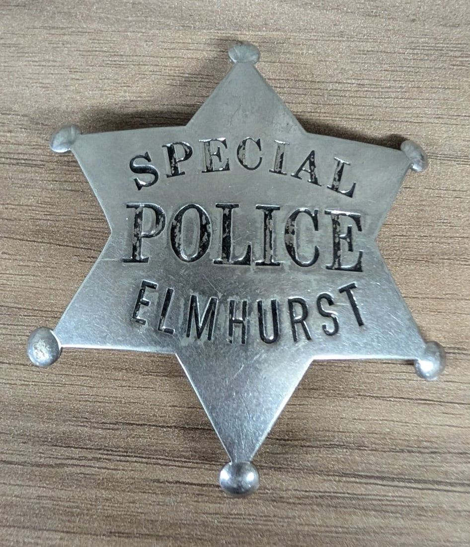 Elmhurst Illinois Special Police Die-Stamped Star Badge: This is a municipal law enforcement badge for the Elmhurst, Illinois Special Police. The badge is constructed from a silver-toned metal, likely nickel silver or chrome-plated brass, in the form of a s