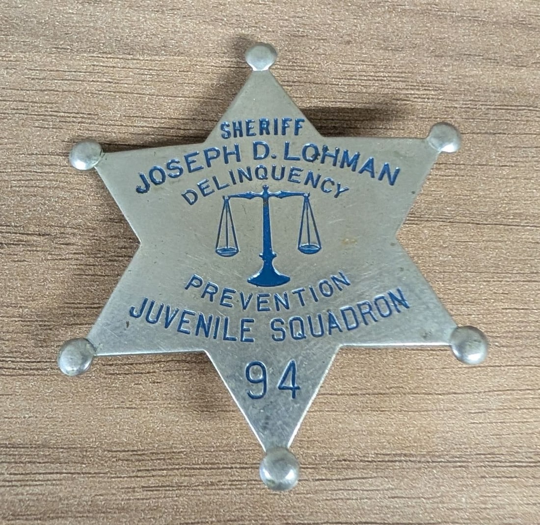 Two Illinois Municipal and Law Enforcement Badges including Joseph D. Lohman Cook County Sheriff: This lot contains two vintage Illinois-related metal badges. The first is a mid-twentieth century Cook County Sheriff's Office badge for the Delinquency Prevention Juvenile Squadron. This six-pointed 