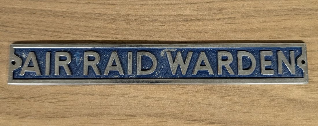 World War II ARP Air Raid Warden Cast Alloy Sign: A World War II era cast metal identification plaque for an Air Raid Warden. This rectangular sign features raised block lettering against a stippled cobalt blue painted background. It is constructed f