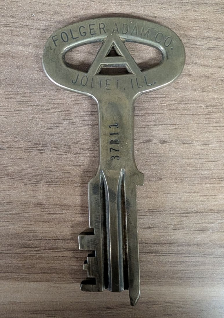 Folger Adam Company Cast Brass Prison Key Joliet Illinois: This institutional detention key was produced by the Folger Adam Company of Joliet, Illinois, a prominent manufacturer of high-security correctional hardware. The key is constructed from solid cast br