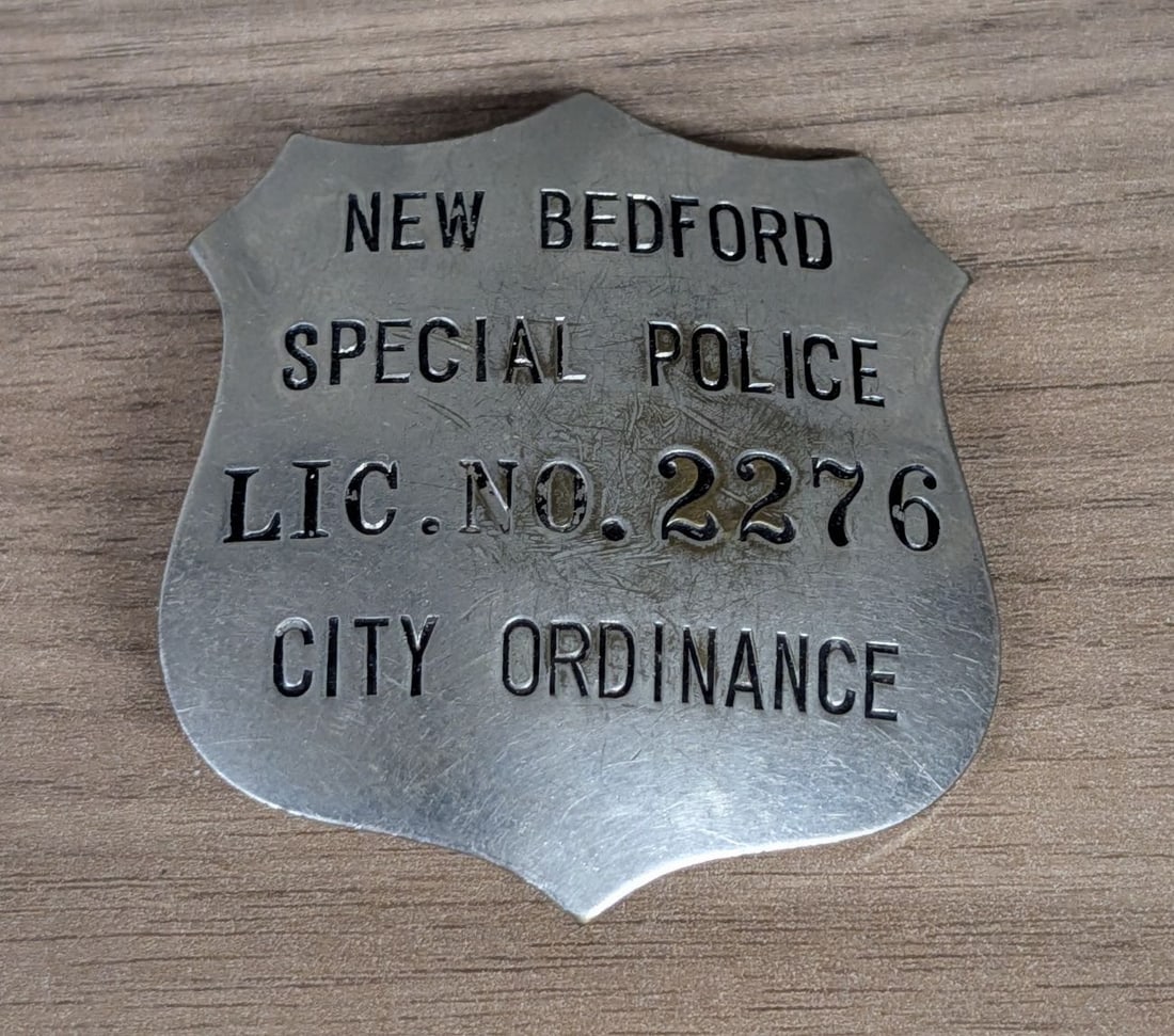 Vintage New Bedford Massachusetts Special Police Shield Badge License No. 2276: This is a vintage stamped metal shield badge issued by the city of New Bedford, Massachusetts. The badge is designated for Special Police and identifies the bearer with License Number 2276 under City 