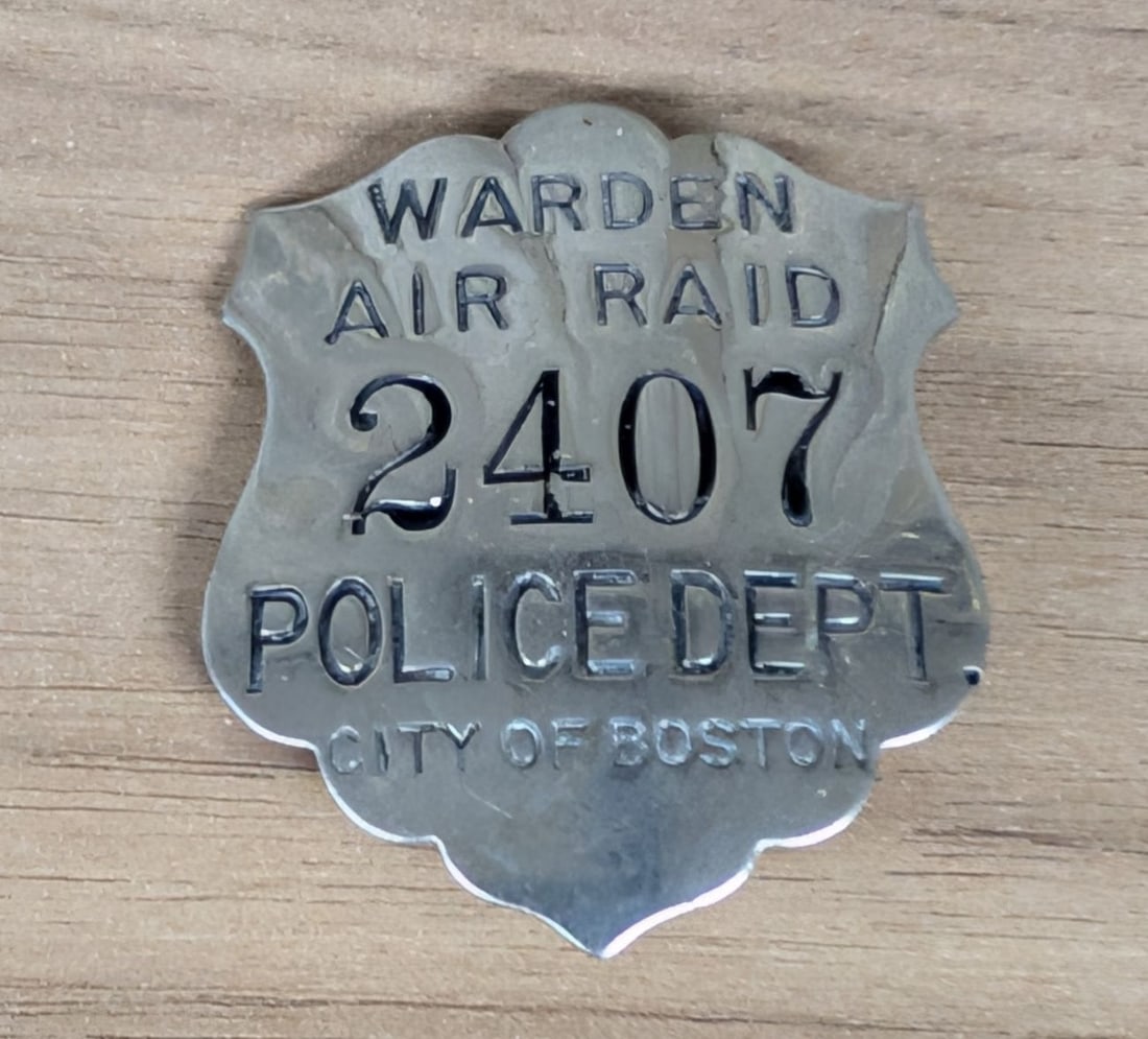 WWII Boston Police Department Air Raid Warden Badge No. 2407: A World War II era official badge for an Air Raid Warden within the Boston Police Department. The shield-shaped badge is constructed from silver-toned metal, likely nickel-plated brass or white metal,