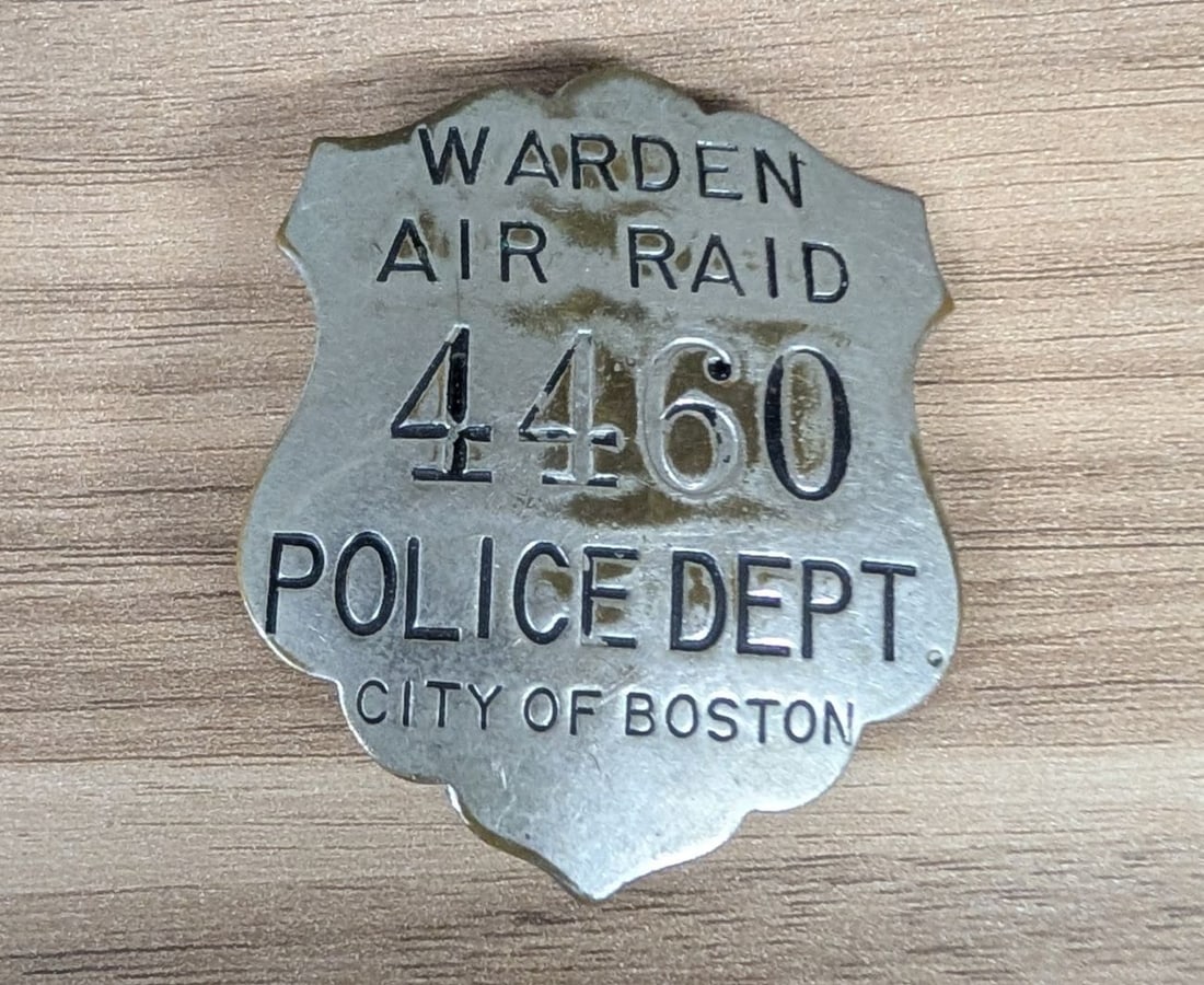 WWII City of Boston Police Department Air Raid Warden Badge No. 4460: A World War II-era civil defense badge issued by the City of Boston Police Department to an Air Raid Warden. The badge is constructed of stamped metal, likely nickel-plated brass or zinc, featuring a 