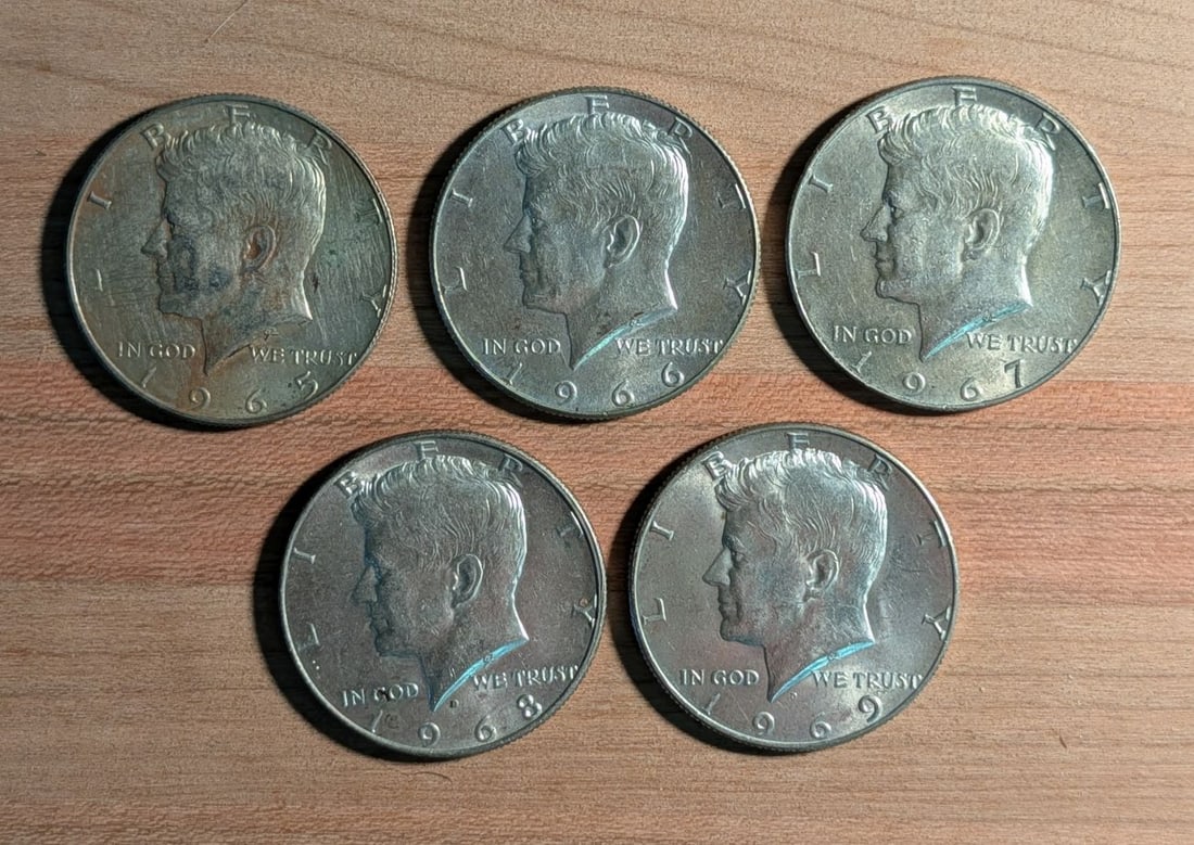 Five US 1965-1969 40% Silver-Clad Kennedy Half Dollars: Five US Kennedy Half Dollars comprising a sequential date run from 1965 to 1969. These coins are of a 40% silver-clad composition, featuring two outer layers of 80% silver and 20% copper bonded to an 