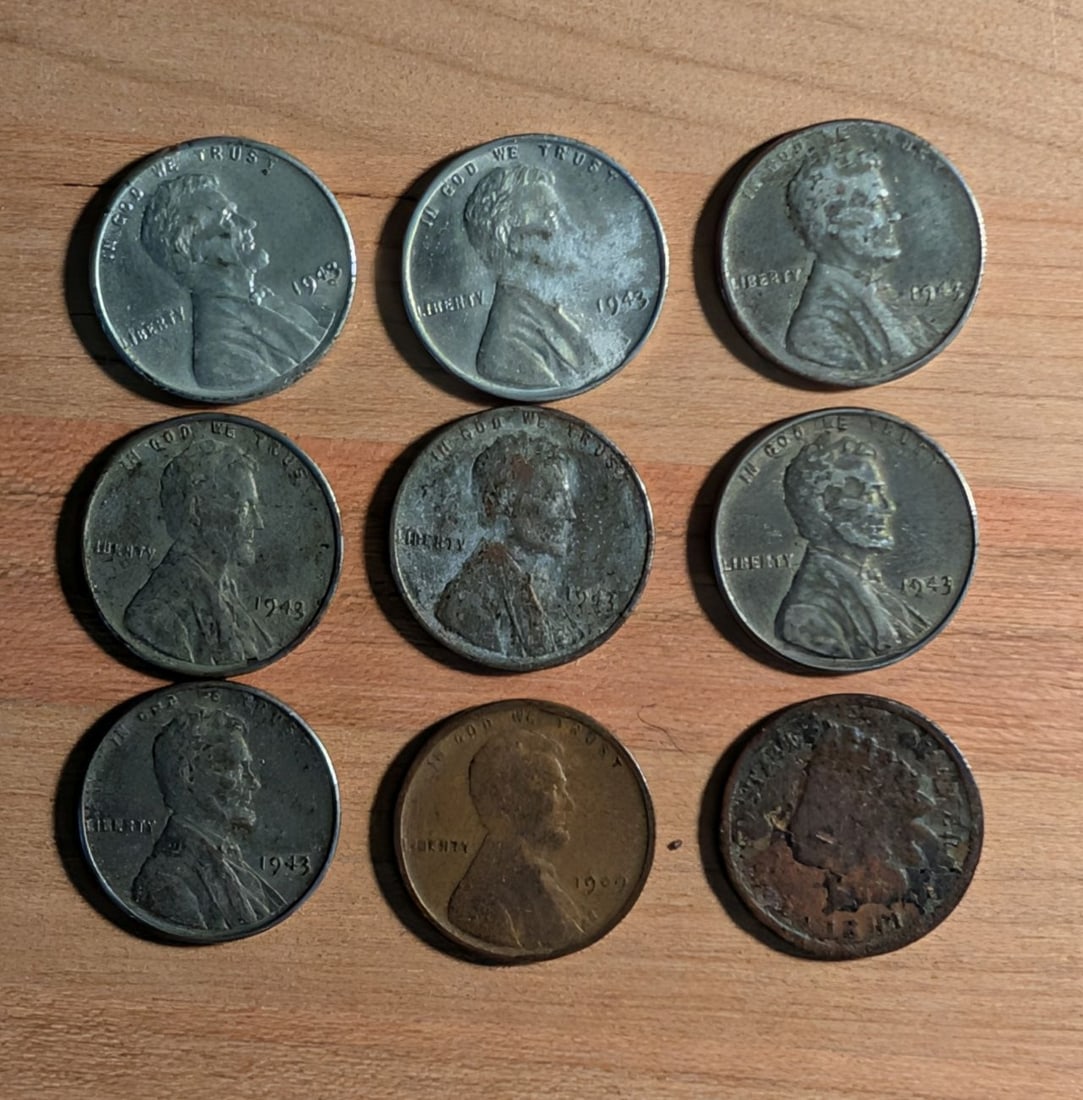 A Group of US One-Cent Coins Including Lincoln Steel and Indian Head Cents: A collection of US one-cent coins including Lincoln steel cents, a 1909 Lincoln wheat cent, and an Indian Head cent. The 1943 Lincoln cents are composed of zinc-plated steel, used as a wartime measure