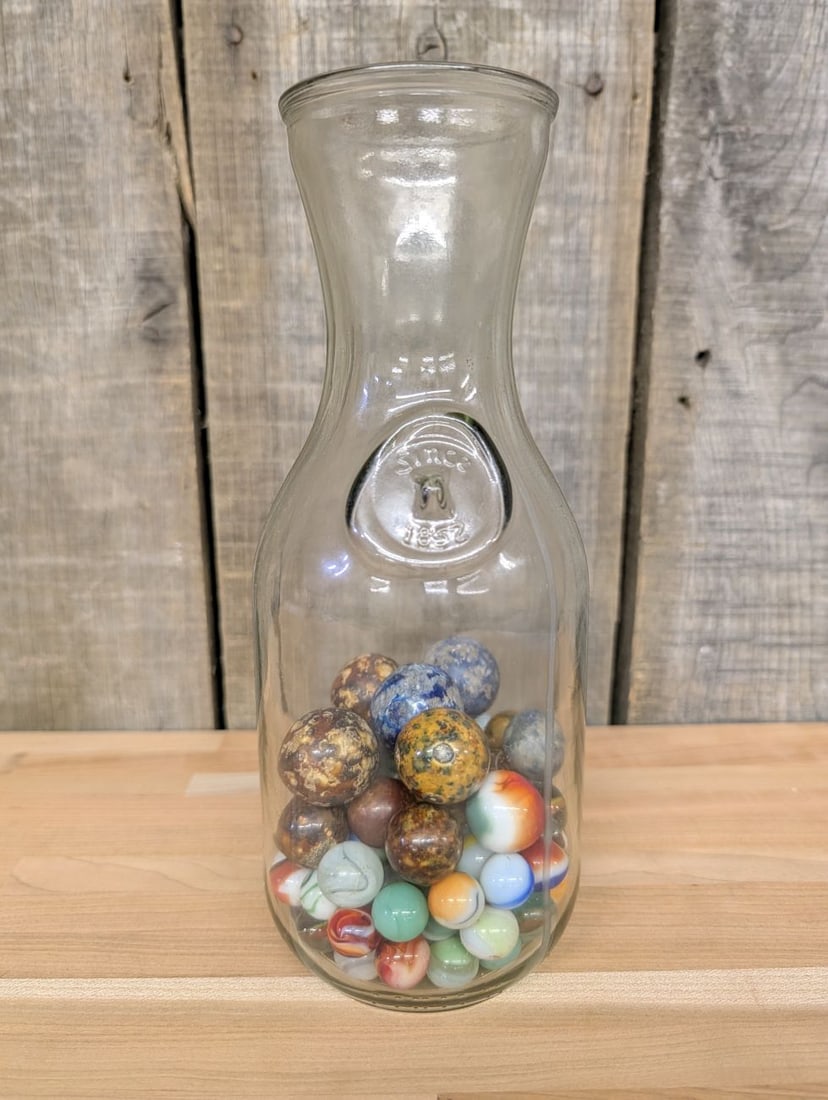 A Collection of Vintage Glass and Clay Marbles in an Embossed Paul Masson Carafe (1 of 7)
