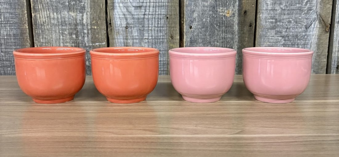 A Set of Four Homer Laughlin Fiesta Bouillon Bowls in Persimmon and Rose: A set of four contemporary vitrified china bouillon bowls from the Fiesta line by the Homer Laughlin China Company. The group includes two bowls in the Persimmon glaze color and two in the Rose glaze 