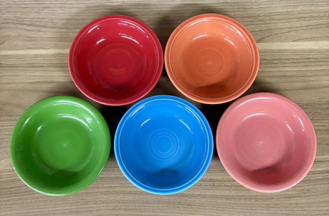 A Set of Five Homer Laughlin Fiesta Fruit Bowls: A set of five vitrified earthenware fruit bowls from the Fiesta line, manufactured by the Homer Laughlin China Company in the United States. The collection features five distinct solid color glazes: S