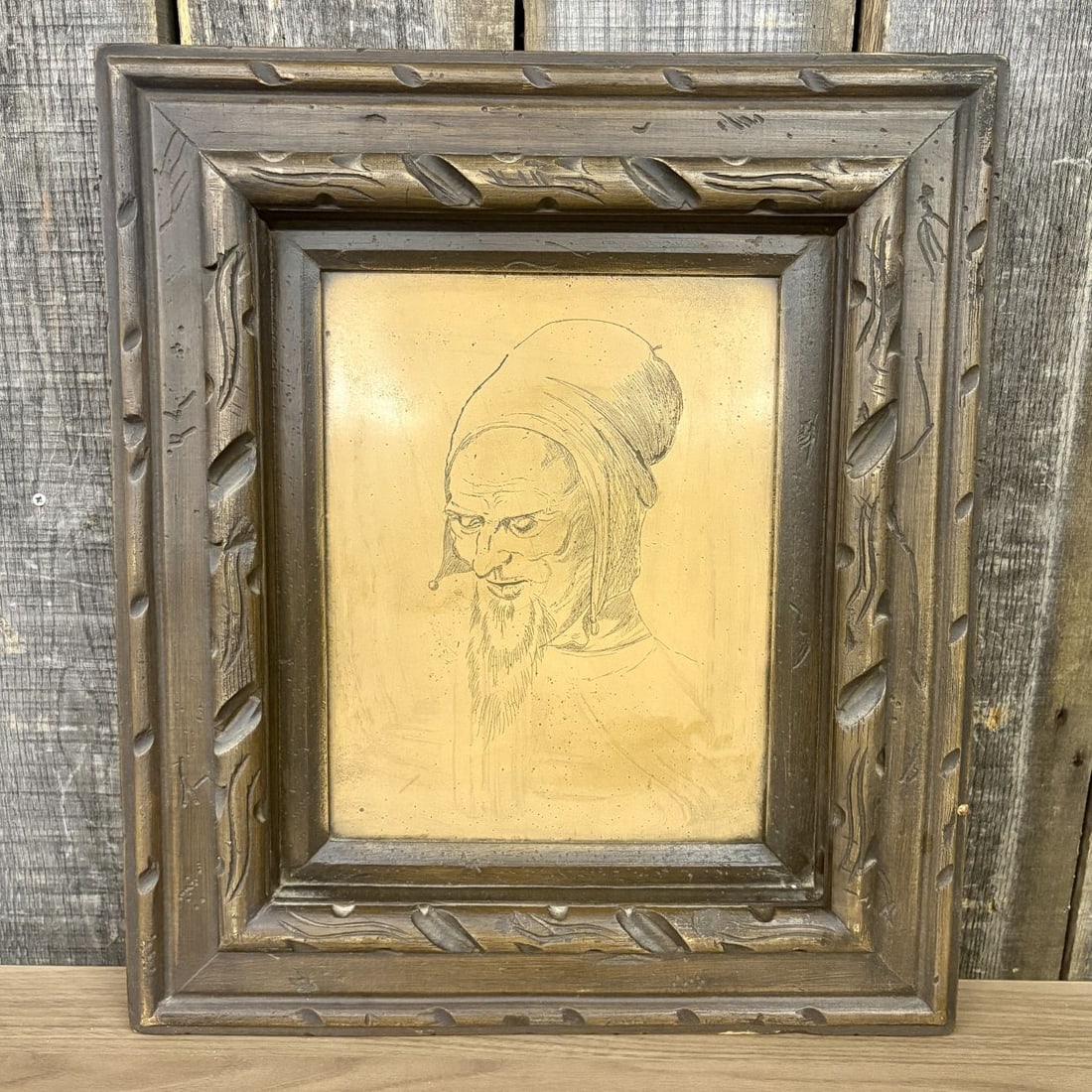 Albrecht Durer Head of an Apostle Print on Gold Toned Board: This work is a reproduction of the 1508 drawing Head of an Apostle by Albrecht Durer. The piece features the profile of an elderly man with a long beard and a hooded cap, rendered in fine black lines 
