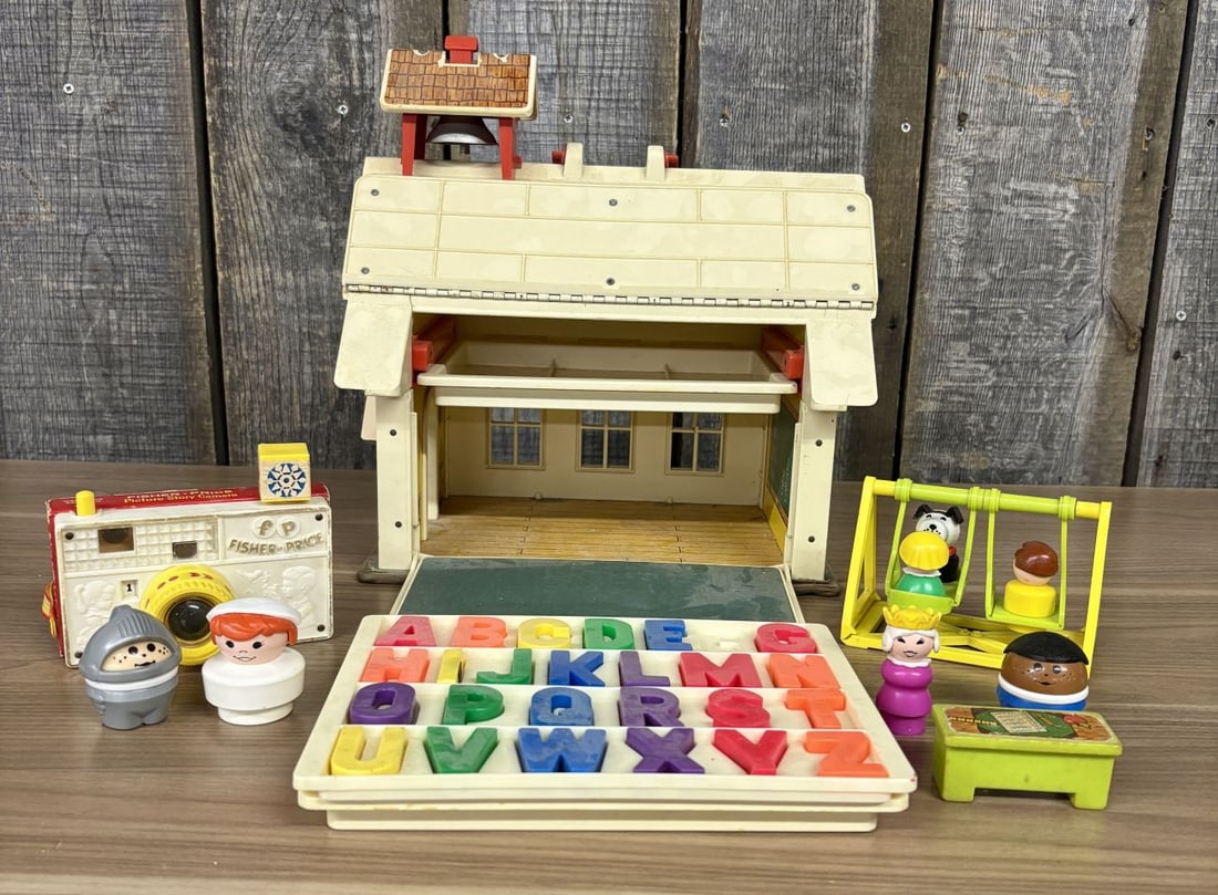 A Collection of Fisher-Price Play Family School and Accessory Toys: This is a collection of vintage toys manufactured by Fisher-Price, primarily featuring the Play Family School set, Model Number 923. The schoolhouse is constructed of molded plastic and lithographed p