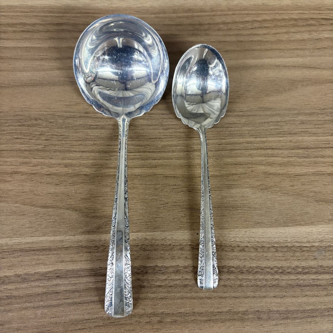 A Pair of Towle Candlelight Sterling Silver Serving Pieces: A pair of solid .925 sterling silver serving pieces manufactured by Towle Silversmiths of Newburyport, Massachusetts. This lot includes one cream ladle and one sugar spoon in the Candlelight pattern, 