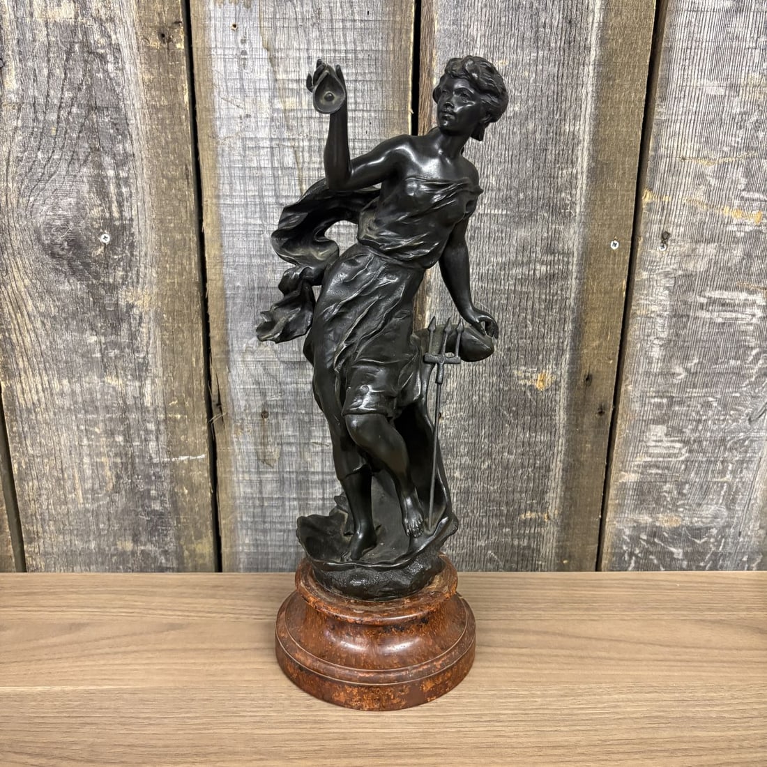 French Belle Epoque Spelter Allegorical Sculpture of a Sea Deity: A French late 19th to early 20th-century allegorical spelter sculpture with a dark bronze-toned patina. The figure depicts a female sea deity, likely Amphitrite, standing atop a base of textured waves