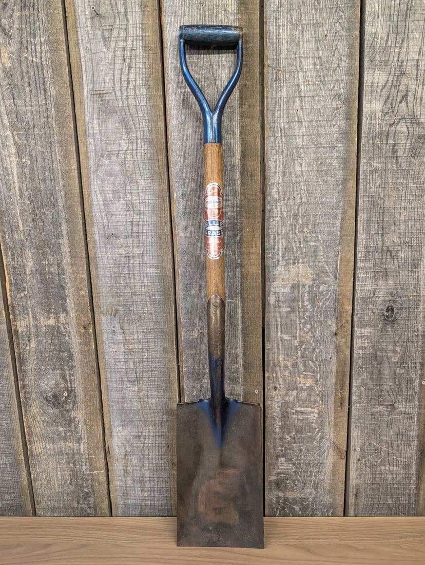 Vintage Belknap Blue Grass Taper Forged D-Handle Square Point Garden Spade: A vintage square-point garden spade manufactured for the Belknap Hardware and Manufacturing Company under the Blue Grass brand. This tool features a taper forged, heat-treated steel blade with a long 
