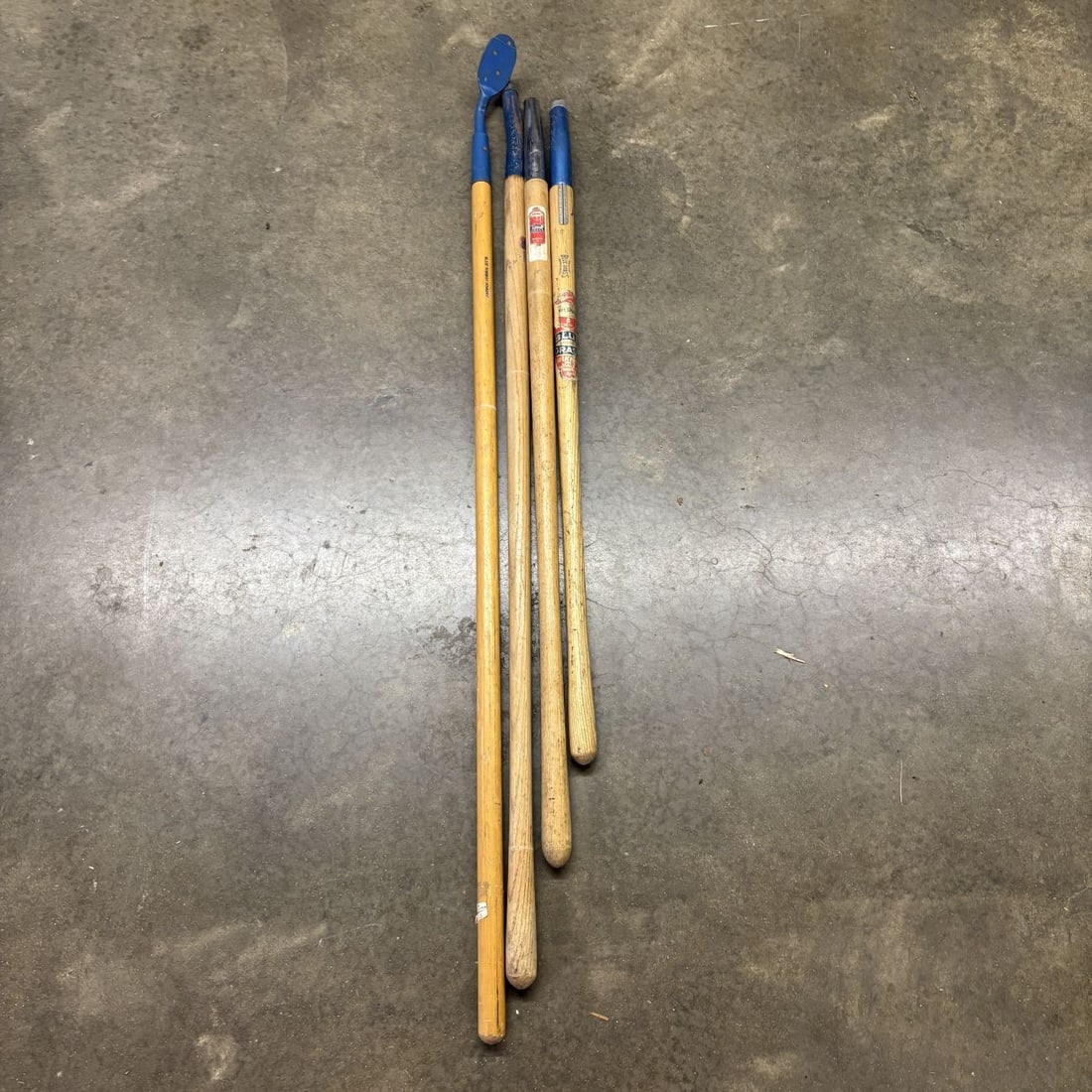 A Group of Belknap Blue Grass and Blue Ribbon Vintage Replacement Tool Handles: A group of vintage turned hardwood replacement handles produced by the Belknap Hardware and Manufacturing Co. of Louisville, Kentucky. These items are branded under the company's Blue Grass and Blue R