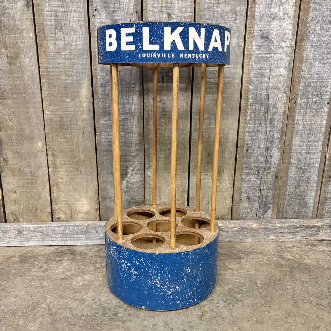 Belknap Hardware and Manufacturing Company Vintage Wooden Retail Display Rack: This vintage retail display rack was produced for the Belknap Hardware and Manufacturing Company of Louisville, Kentucky. The stand is constructed from two circular wooden tiers connected by seven ver