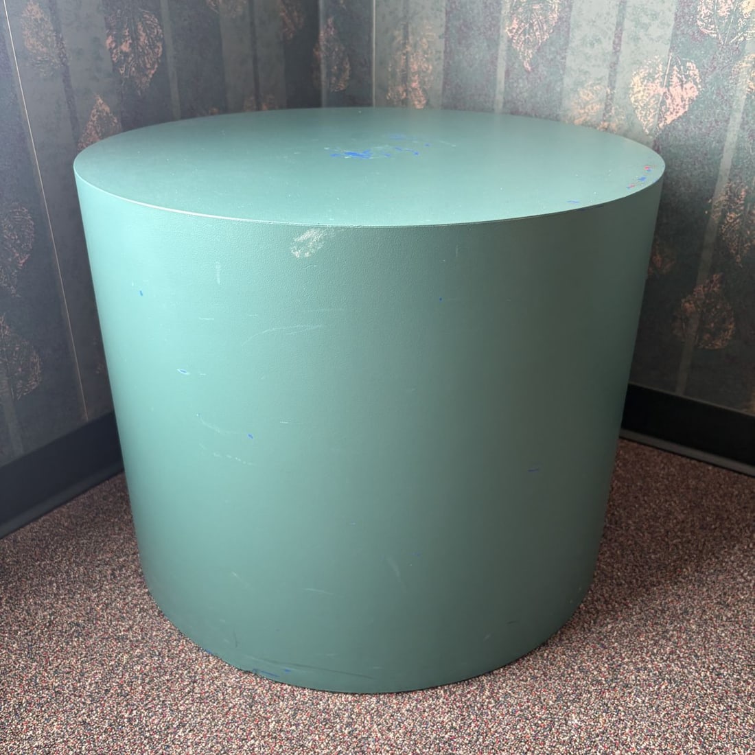 Postmodern Teal Laminate Cylindrical Pedestal Side Table: This cylindrical pedestal side table, suitable for use as a display plinth, is constructed with a circular flat top and a matching drum-style base. The piece is finished in a textured teal-colored lam
