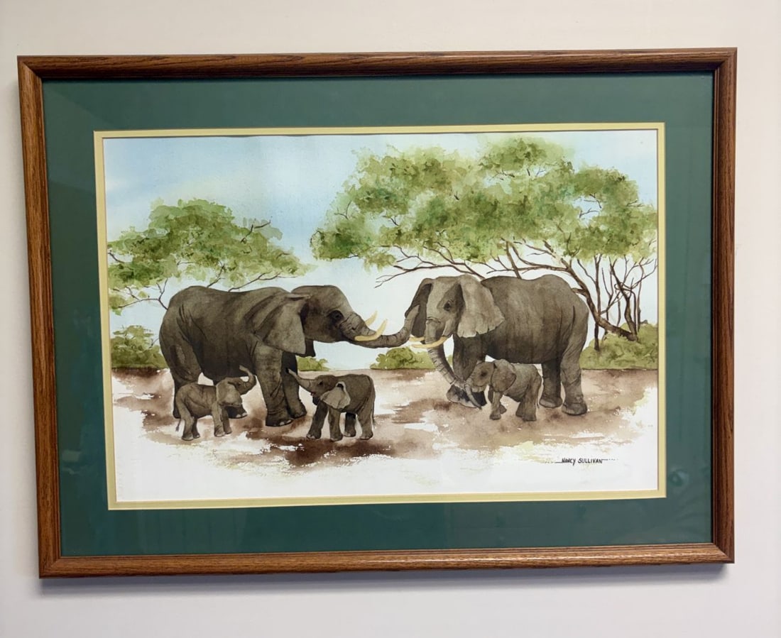 Nancy Sullivan African Elephant Family Savanna Landscape Watercolor: A watercolor on heavy textured paper depicting a family of five African elephants, including two adults and three calves, in a savanna landscape with acacia trees. The work is executed in an illustrat