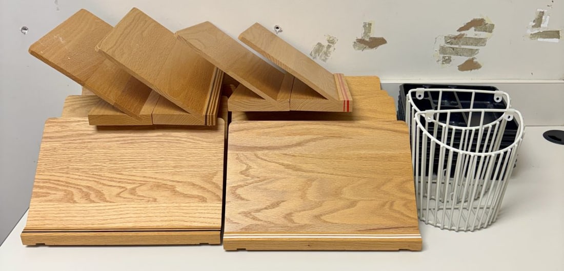 An Assortment of Wooden Document Stands, Plastic Desk Trays, and Wire Wall Baskets: A collection of office and educational organizational supplies. This lot features several angled wooden document or book stands constructed from light-toned wood with a visible grain and clear-coated 