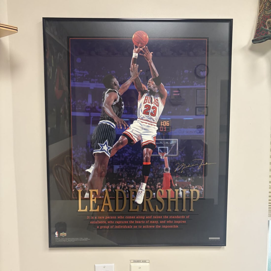 Upper Deck Michael Jordan Leadership 72-10 Limited Edition Framed Poster: A framed limited-edition lithographic poster titled Leadership, featuring Chicago Bulls player Michael Jordan. The central image depicts Jordan in a white home jersey executing a jump shot over an Orl