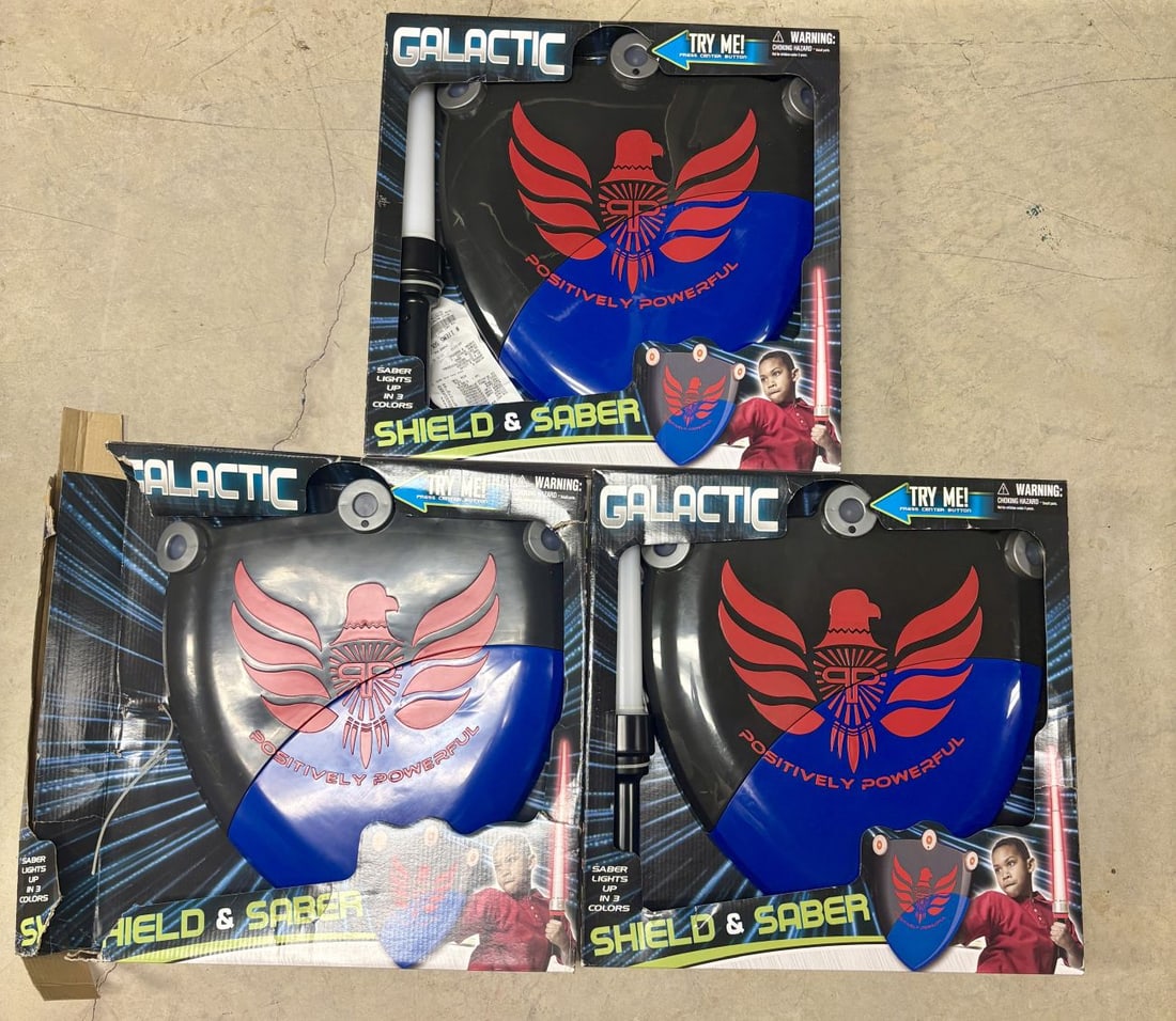 Three Galactic Shield and Saber Toy Combat Sets: A lot consisting of three children's toy combat sets by the brand Galactic. Each set comprises one handheld shield and one saber toy. The shields are constructed of black and blue plastic, decorated w