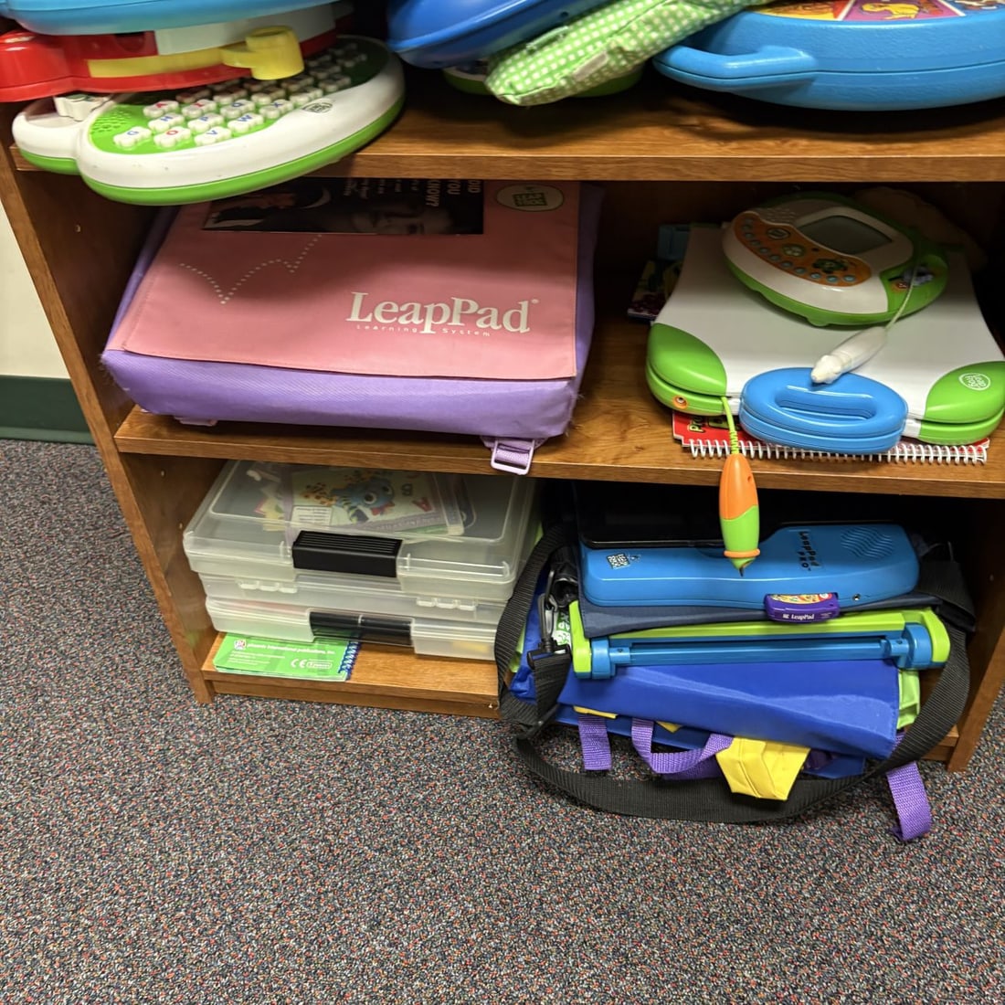 A Collection of LeapFrog Educational Toys, a Welch Allyn Pediatric Diagnostic Center, and a Three-Sh - 7