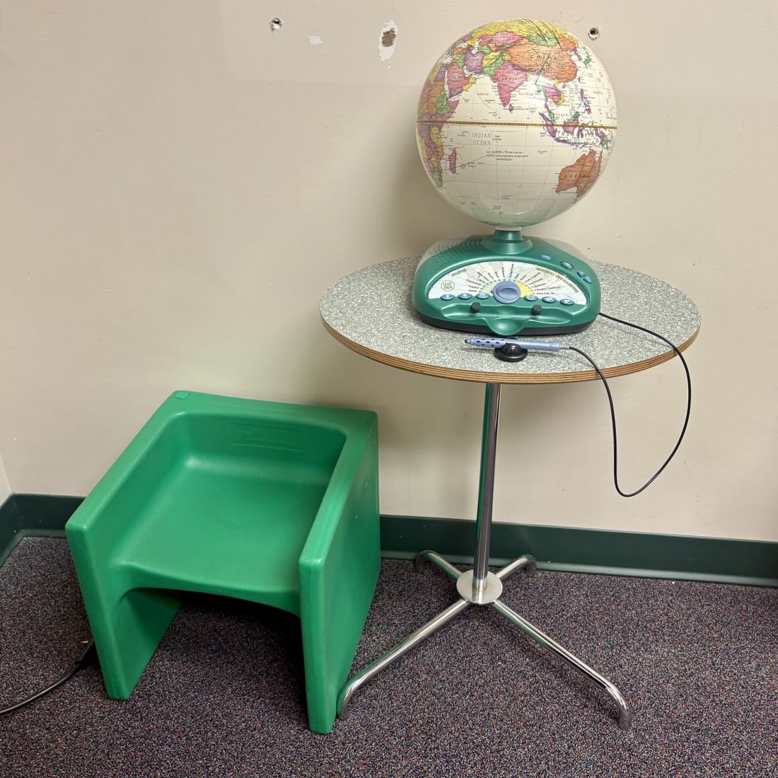 Three Piece Childrens Educational Learning Station Including LeapFrog Explorer Challenge Interactive: A set of three educational items and children's furniture comprising an interactive electronic globe, a molded cube chair, and a pedestal table. The interactive globe features a green plastic base