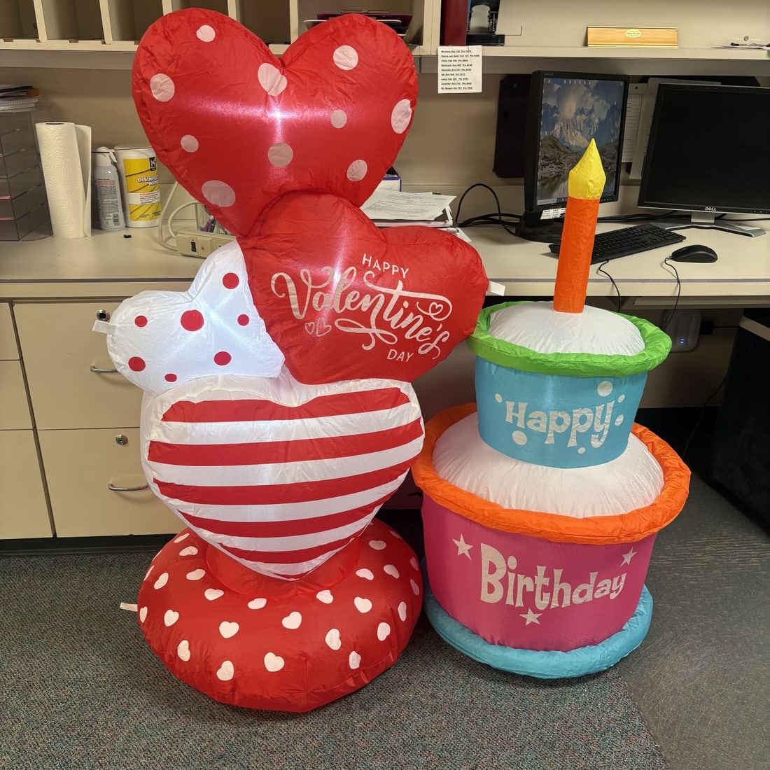 Valentine's Day Heart Stack and Birthday Cake Inflatable Decorations: Two celebratory inflatable decorations consisting of a Valentine's Day themed heart stack and a two-tiered birthday cake. The Valentine's inflatable is a vertical arrangement of four stylized hearts a