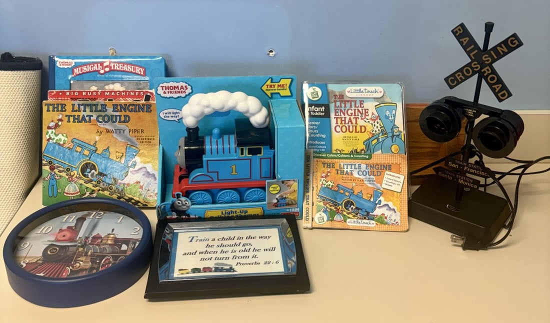 Fisher-Price Talking Thomas Toy, Books & Railroad Crossing Lamp Train Collection: This assortment of train-themed nursery and playroom items features a variety of toys, literature, and decorative pieces. Included is a Fisher-Price Thomas & Friends Light-Up Talking Thomas locomotive