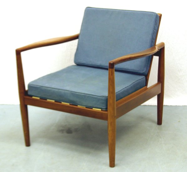 A Mahogany Robin Day Chair for Hille: Of mahogany, construction with cane backing and rubber webbing and blue cotton cushions. Designed by Robin Day. Manufactured by Hille. Circa 1950's.