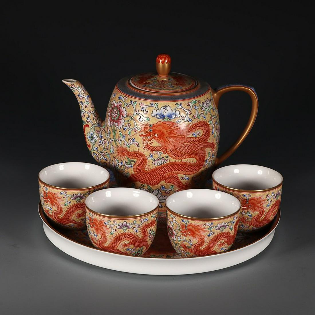 QIANLONG MARK FAMILLE ROSE DRAGON AND PHOENIX: Time: Qianlong Period 18 Century / Teapot height 14.6cm Mouth-Diameter 6.5cm Base-Diameter 7cm / Cup height 4.8cm Diameter 6.4cm / Tea tray height 2.3cm Diameter 22.2cm