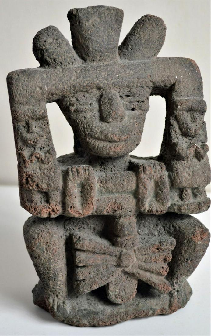 PRE COLUMBIAN CARVED FIGURE MESOAMERICAN OLMEC: Pre-Columbian volcanic stone (tuff) carved figural sculpture with a headdress. Possibly Olmec in origin. It is in good condition and appears to have been wall or niche mounted at one point due to the 