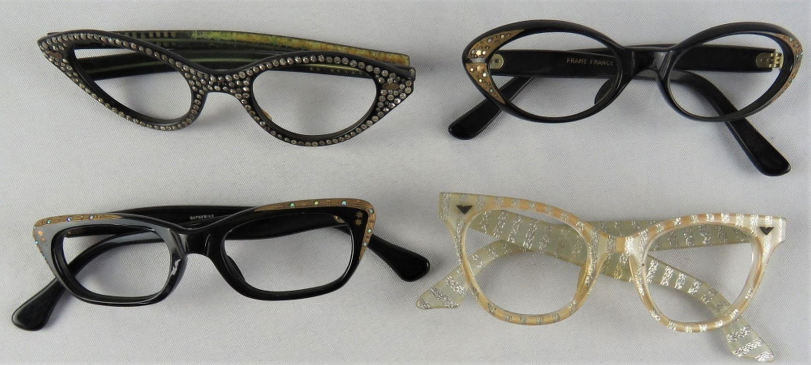 4 VINTAGE 1950's RHINESTONE CATEYE EYEGLASSES: Lot of 4 vintage eyeglass / sunglass frames, circa 1950's 1960's. Cat eye and rhinestone styles. 2 marked made in France. Some New Old Stock (NOS). May have some age related imperfections. Provenance: